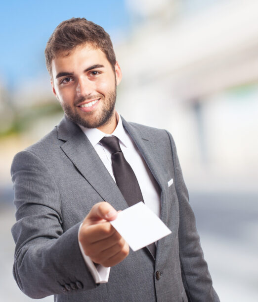 portrait of handsome business man offering his visit card